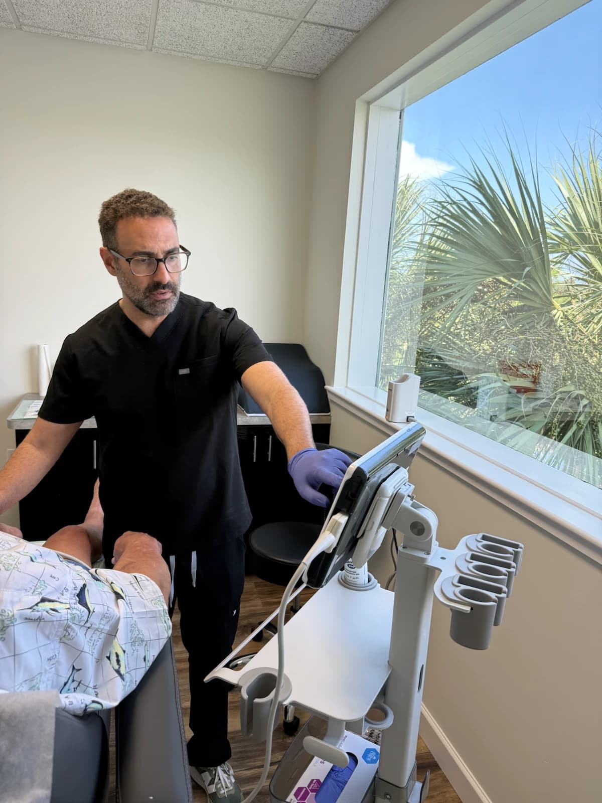 Dr. Ali Golshan using ultrasound at Beach Wellness MD